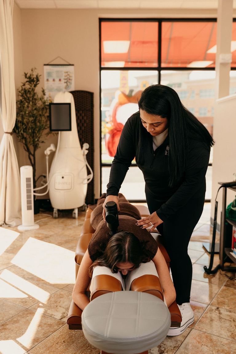 Dr. Rina Patel-Jerls giving a gentle chiropractic adjustment at Alpha Chiropractic in Cape Girardeau